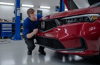 Technician inspecting Honda sedan-Eugene certified collision repair Technician inspecting Honda sedan-Eugene certified collision repair